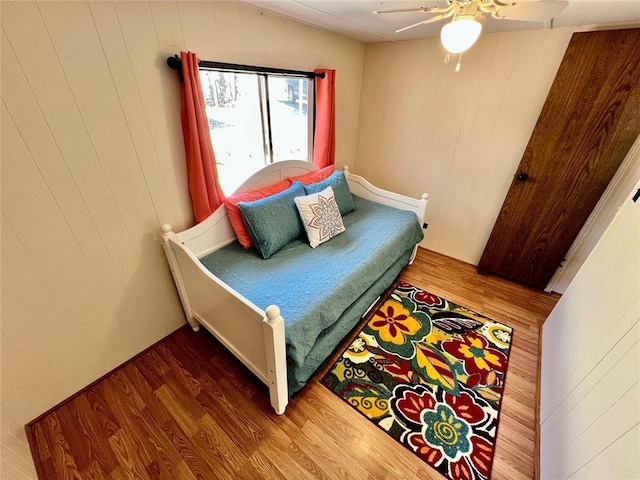 bedroom featuring a ceiling fan and wood finished floors