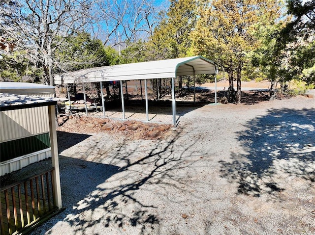 view of outdoor structure with a carport and driveway