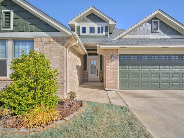 view of front of home with a garage, a shingled roof, concrete driveway, and brick siding