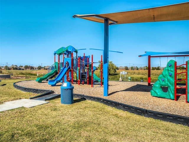 community jungle gym featuring a yard