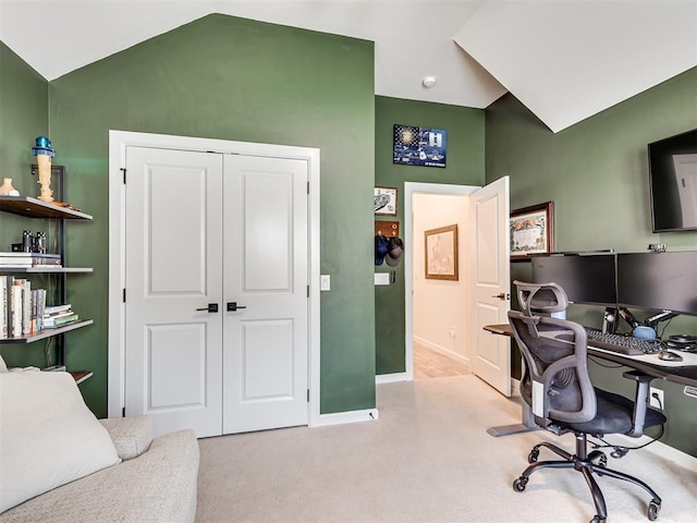 office area with vaulted ceiling, carpet floors, and baseboards