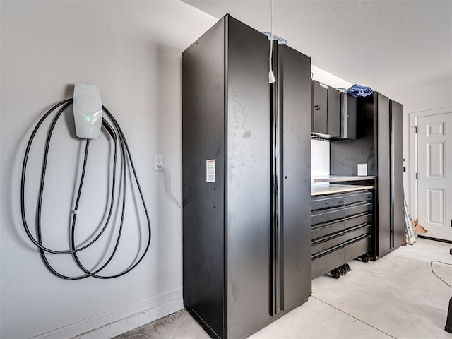 interior space with light countertops and unfinished concrete flooring