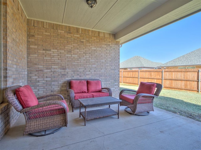 view of patio / terrace with an outdoor hangout area and fence