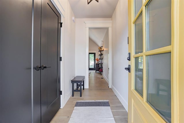 interior space featuring light wood-style flooring and baseboards