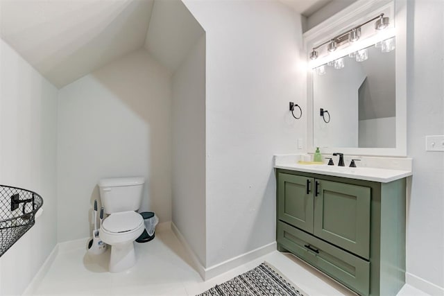 half bath with tile patterned flooring, vanity, toilet, and baseboards