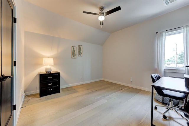 office featuring light wood finished floors, baseboards, visible vents, lofted ceiling, and ceiling fan