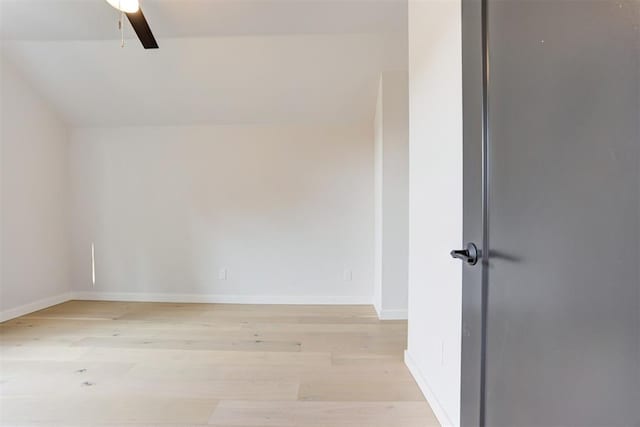 additional living space with light wood-type flooring, ceiling fan, and baseboards