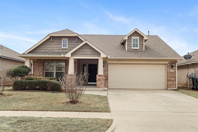 view of front of property with roof with shingles, brick siding, an attached garage, a front yard, and driveway