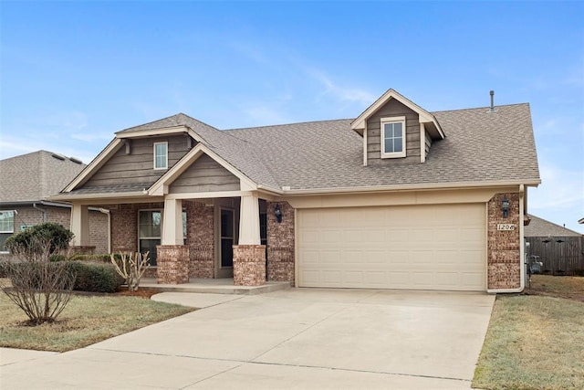 view of front of house with a garage, concrete driveway, brick siding, and a shingled roof