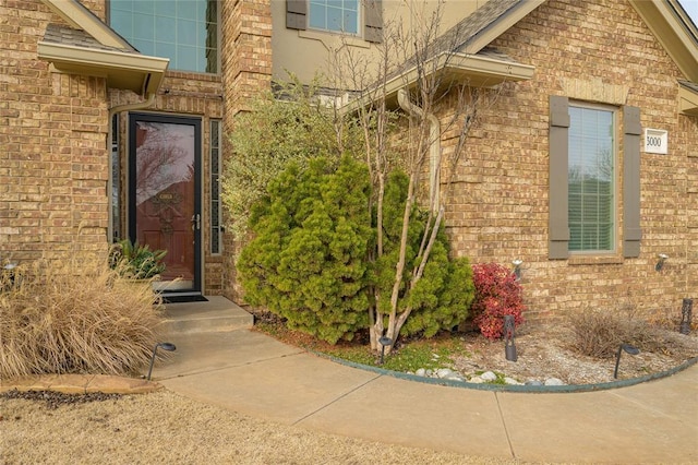 doorway to property with brick siding