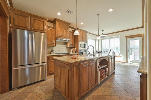 kitchen featuring visible vents, appliances with stainless steel finishes, brown cabinetry, and a sink