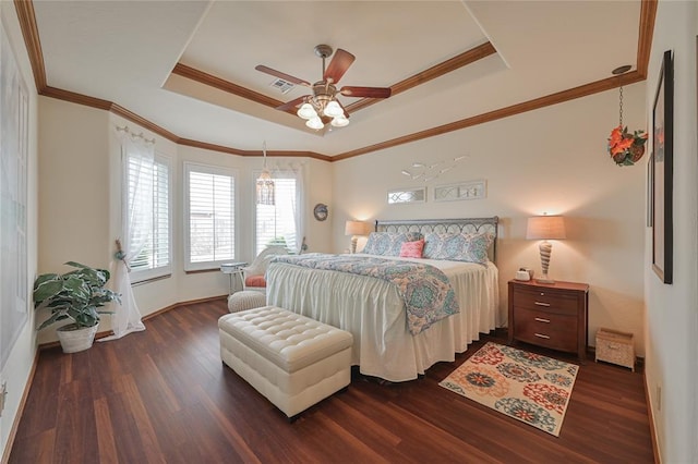 bedroom featuring dark wood-style flooring, a raised ceiling, a ceiling fan, and crown molding