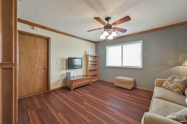 unfurnished living room featuring ceiling fan, a textured ceiling, baseboards, ornamental molding, and dark wood finished floors