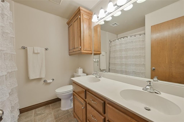 bathroom with toilet, baseboards, visible vents, and a sink