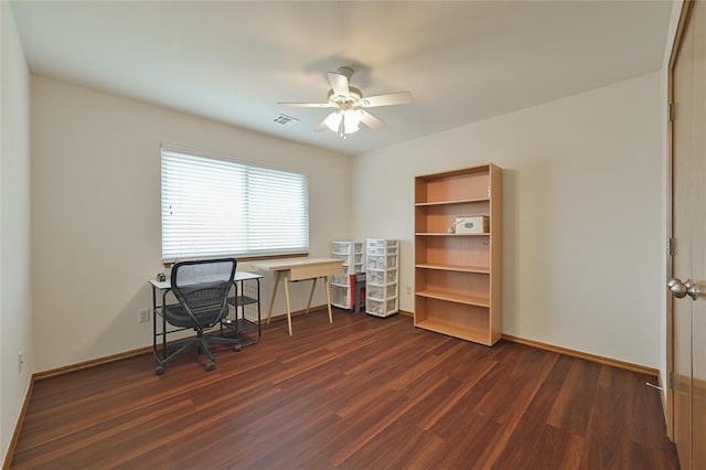 office space featuring dark wood-style floors, baseboards, visible vents, and a ceiling fan