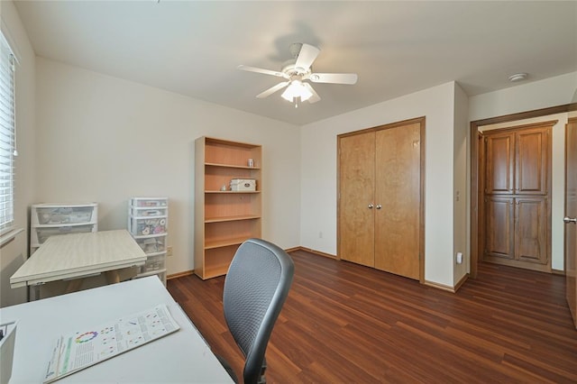 office space featuring dark wood-style floors, ceiling fan, and baseboards