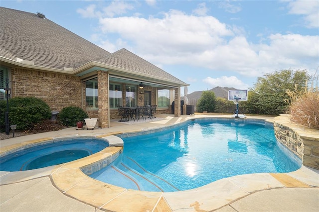 view of swimming pool with a patio, central AC, and a pool with connected hot tub