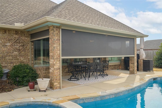 view of swimming pool with a patio area, central AC unit, and a fenced in pool