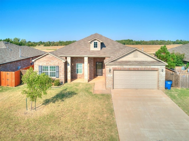 view of front of house with a garage, driveway, a front yard, and fence