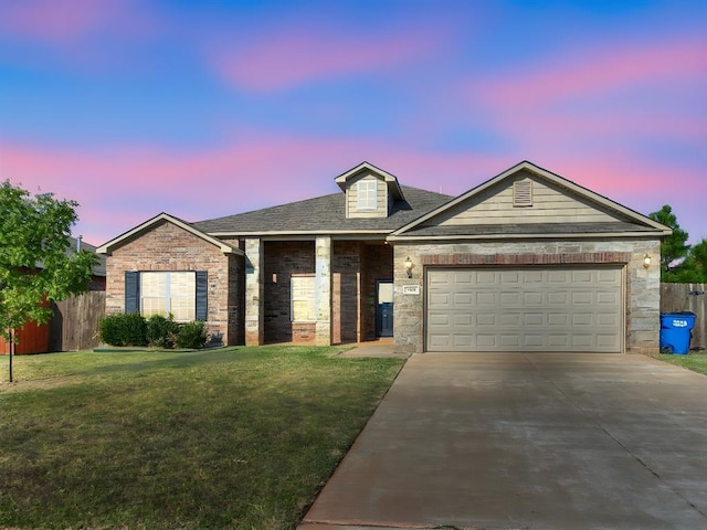 view of front of home featuring concrete driveway, a yard, an attached garage, and fence