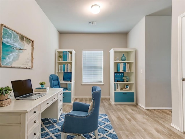 office area featuring baseboards, visible vents, and light wood finished floors