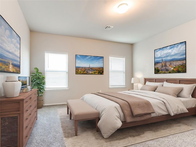 carpeted bedroom featuring visible vents and baseboards