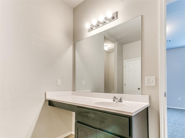 bathroom with visible vents, vanity, and baseboards