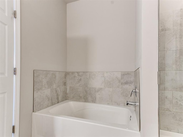 bathroom with a garden tub