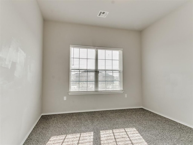 carpeted spare room with baseboards and visible vents