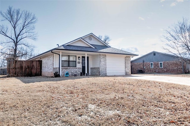 ranch-style house with brick siding, a shingled roof, fence, a garage, and driveway