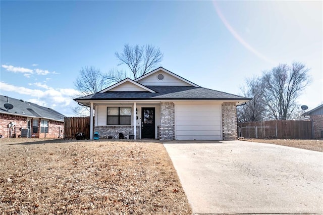 ranch-style house featuring driveway, a garage, fence, and brick siding