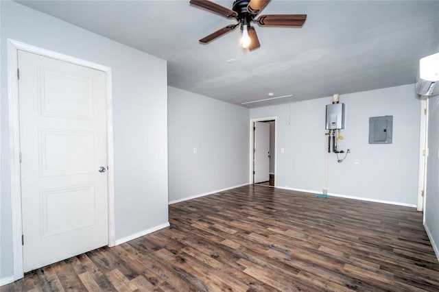 spare room with a wall unit AC, baseboards, electric panel, dark wood-style floors, and attic access