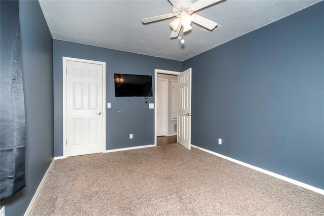 unfurnished bedroom with a ceiling fan, baseboards, and carpet flooring