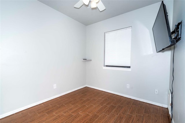 unfurnished room with ceiling fan, baseboards, and wood finished floors