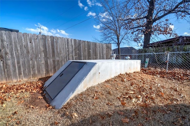 view of storm shelter with fence