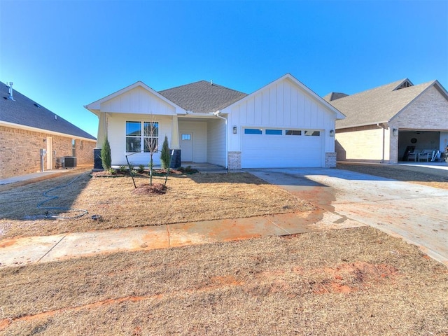 ranch-style home featuring an attached garage, concrete driveway, board and batten siding, and brick siding