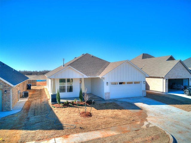 view of front of house featuring brick siding, a shingled roof, board and batten siding, a garage, and driveway