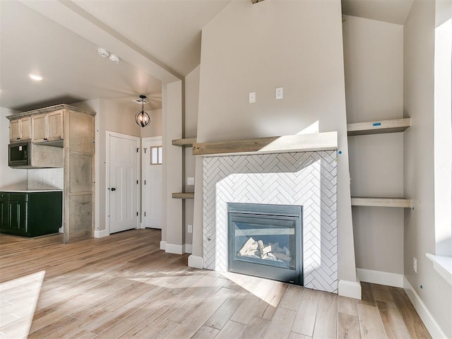 unfurnished living room featuring a fireplace, light wood-style flooring, and baseboards