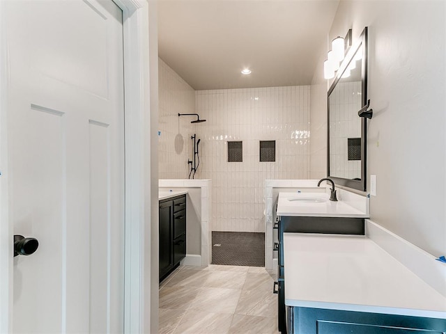 bathroom with walk in shower and vanity