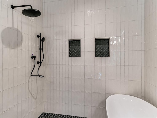 full bath featuring a soaking tub and a tile shower