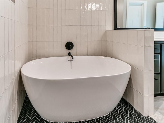 bathroom with a freestanding bath and tile walls