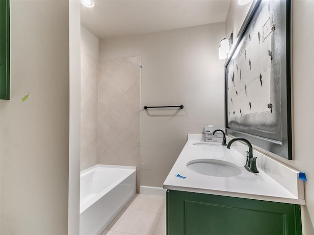 bathroom with baseboards, double vanity, a sink, and tile patterned floors