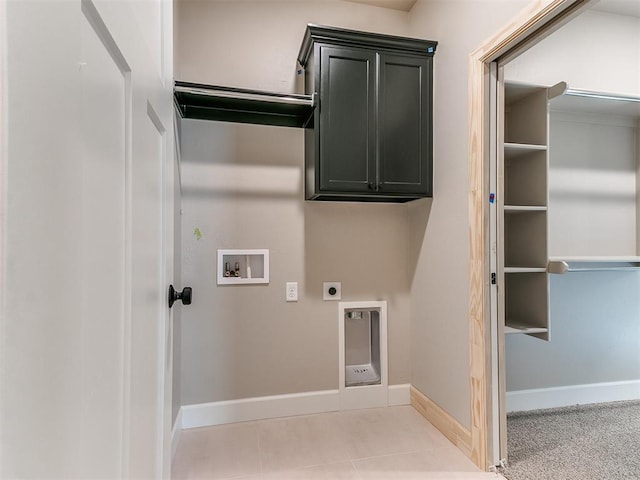 laundry room with hookup for a washing machine, hookup for an electric dryer, baseboards, cabinet space, and tile patterned floors