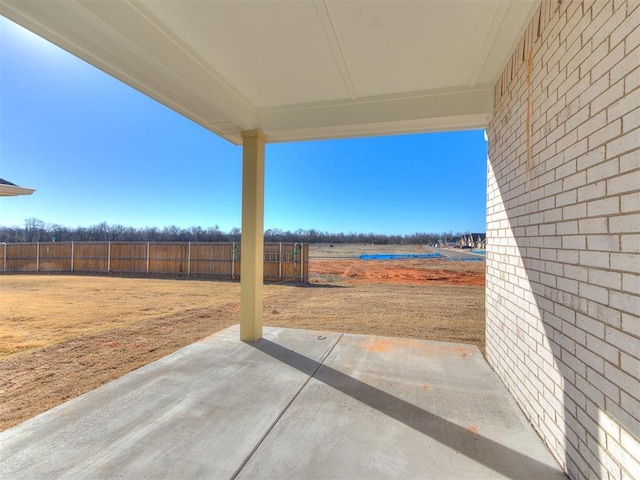 view of patio featuring fence