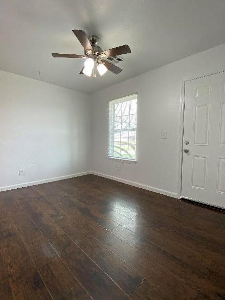 944 SE 14th St, Oklahoma City, OK 73129 - unfurnished room with ceiling fan, baseboards, and dark wood finished floors