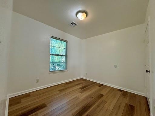 944 SE 14th St, Oklahoma City, OK 73129 - unfurnished room featuring visible vents, baseboards, and dark wood finished floors