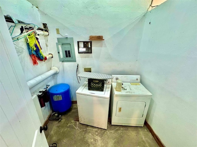 washroom with laundry area, washing machine and dryer, electric panel, and baseboards