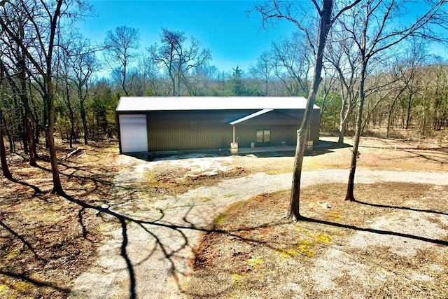 exterior space with driveway and an outdoor structure