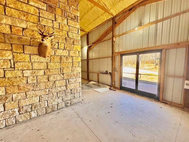 misc room with concrete flooring and metal wall