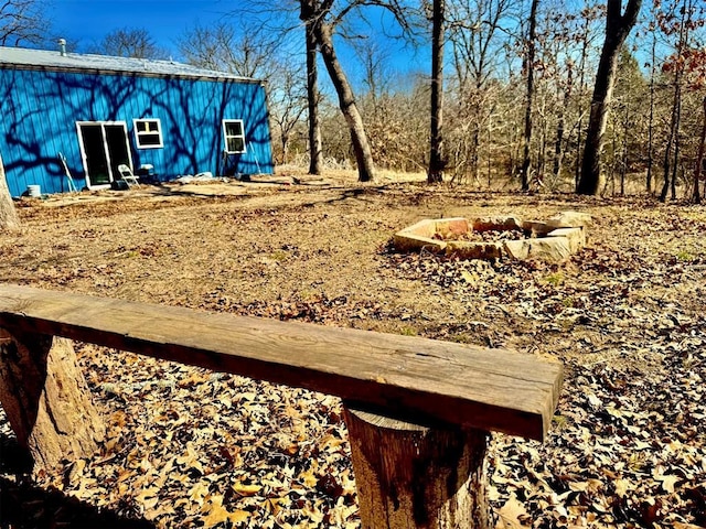 view of yard with an outbuilding and a fire pit